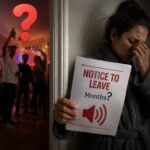 Distressed tenant holding a notice to leave notice while noisy neighbours party next door
