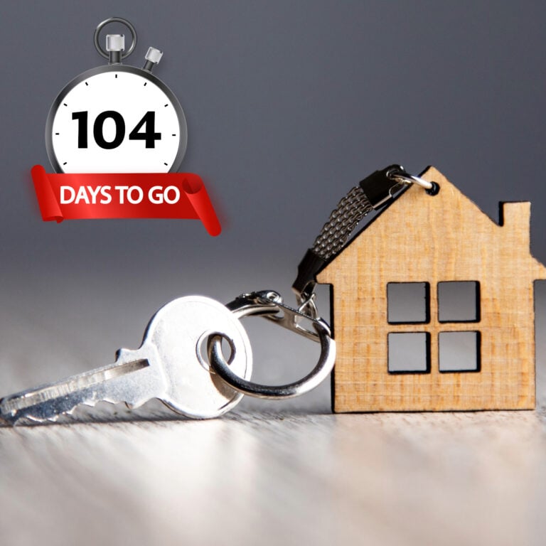 Wooden house keyring beside a key and stopwatch showing 104 days to exchange on UK home sales