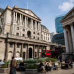 Bank of England building with red London bus in front, symbolising UK property and financial markets